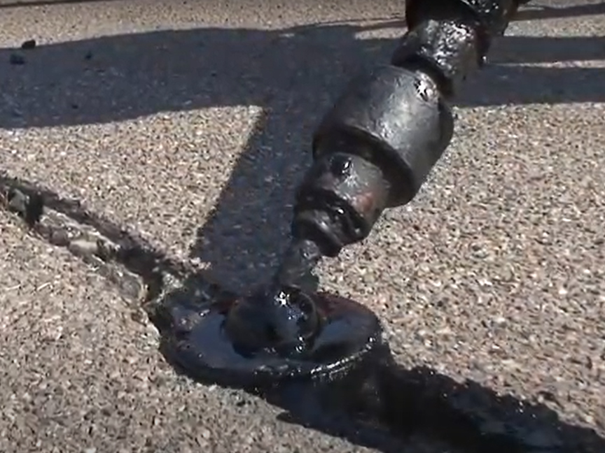 Crack Sealing An Asphalt Parking Lot Dallas