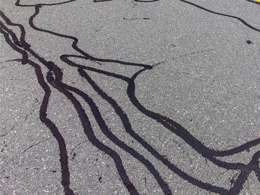 Crack Sealing In Parking Lot Shopping Center