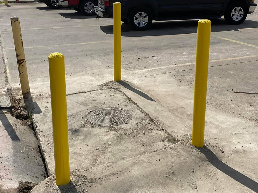 Yellow Bollard Installation In Concrete