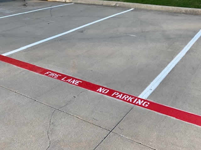 Parking stall lines and directional arrows in Gainesville TX